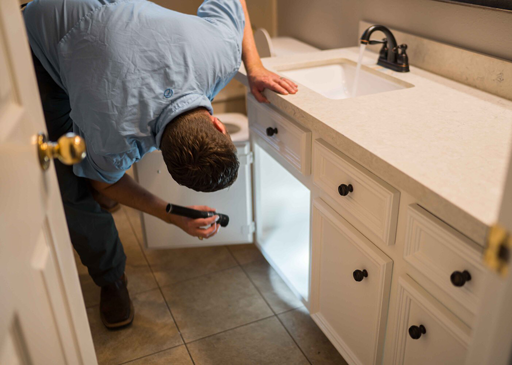 Under sink inspection looking for leaks